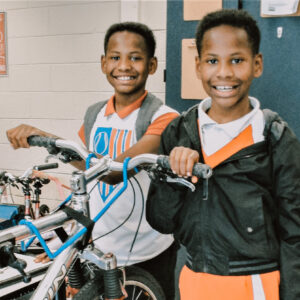 twin kids in bike shop